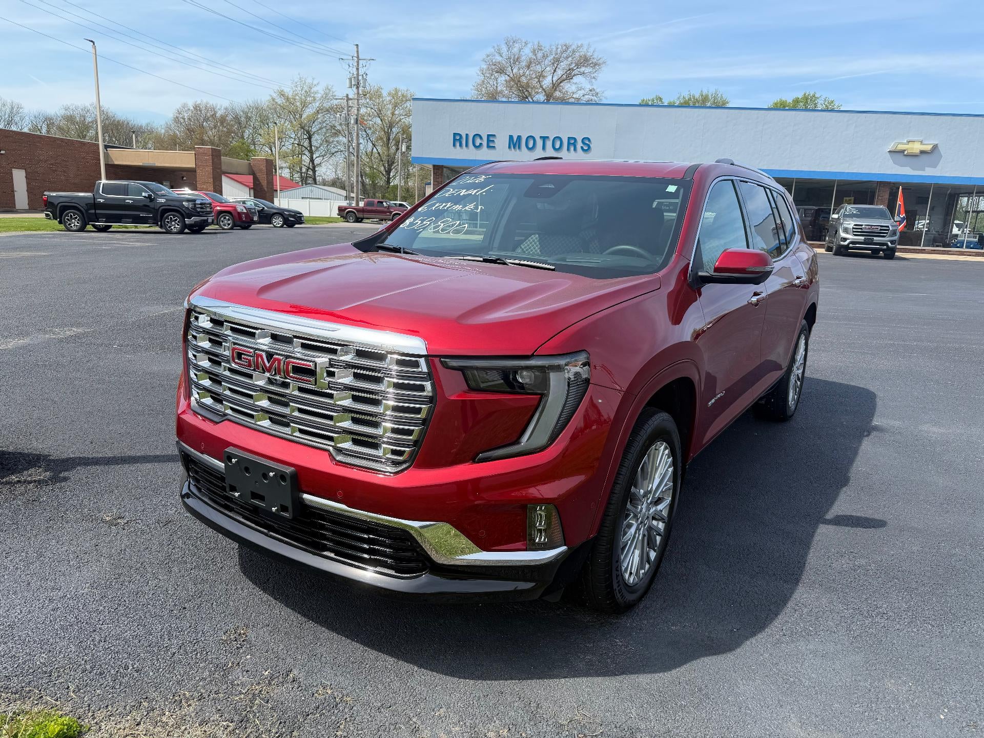 2026 GMC Acadia Denali in Volcanic Red Tintcoat — front three-quarter view