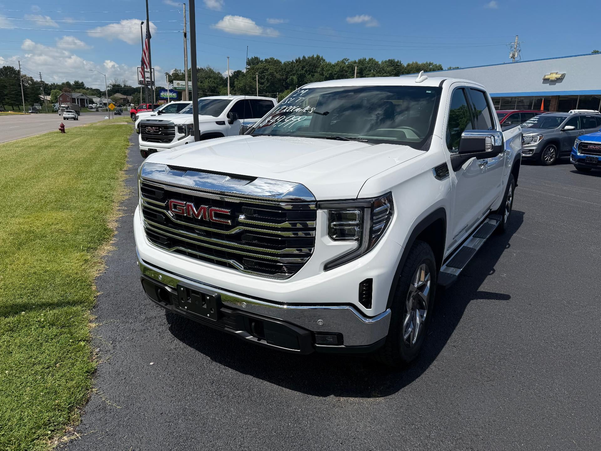 2024 GMC Sierra 1500 SLT in Summit White — front three-quarter view
