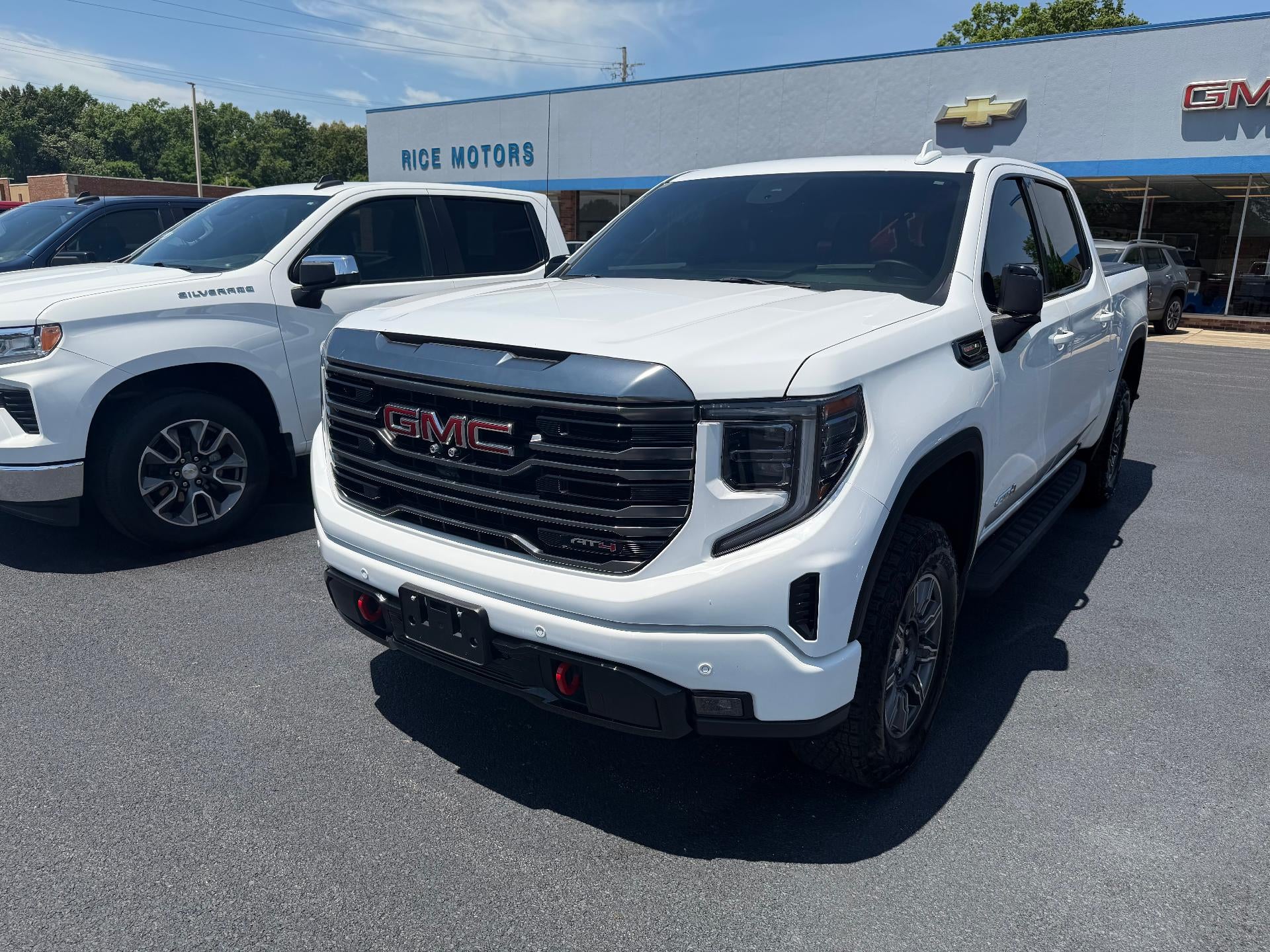 2024 GMC Sierra 1500 AT4 in Summit White — front three-quarter view